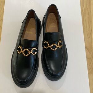 Black platform shoes with gold-tone design